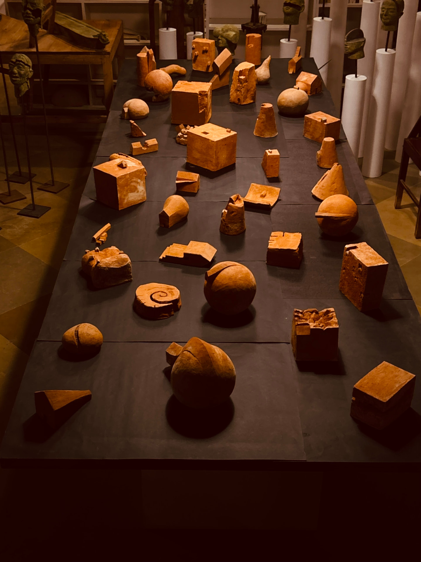 Ceramic City installation view — terracotta structures spread across a dark base